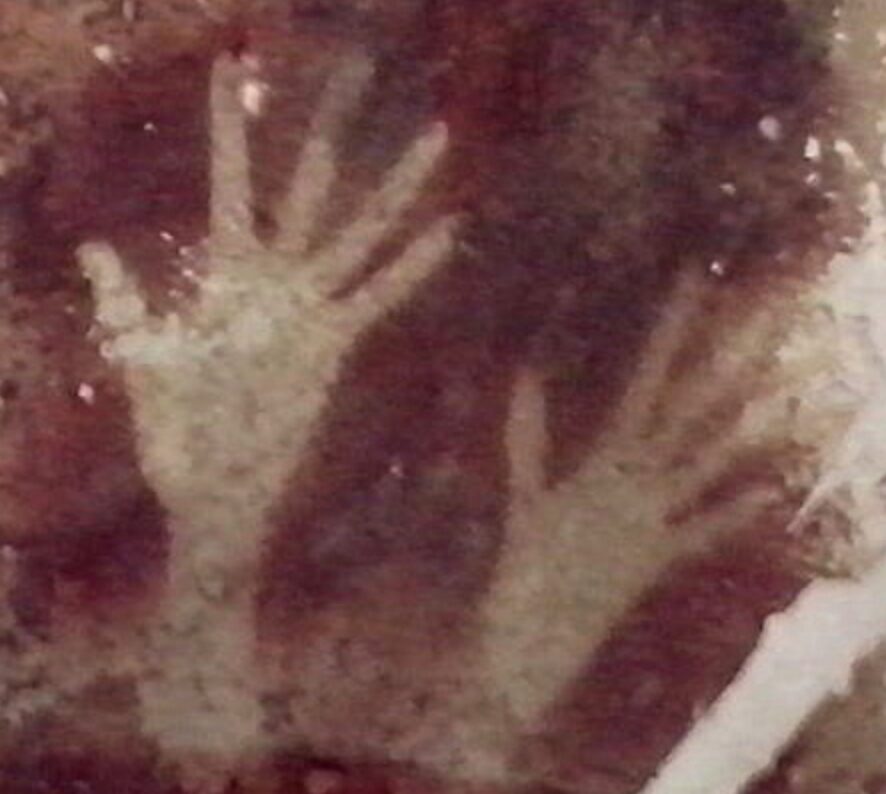 Hand stencils on a cave wall, about 40,000 BCE